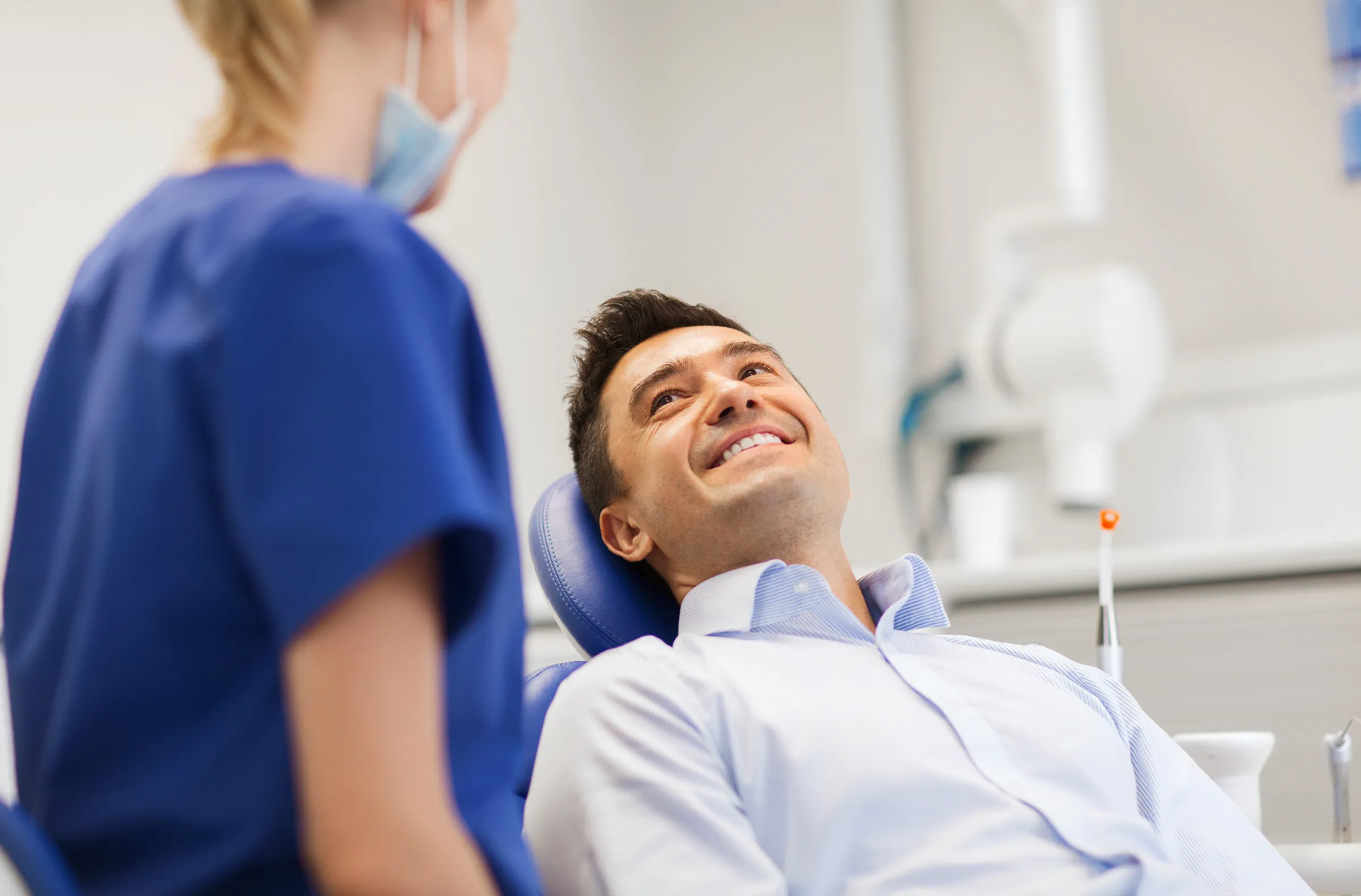 Patient smiling in the chair during a dental exam