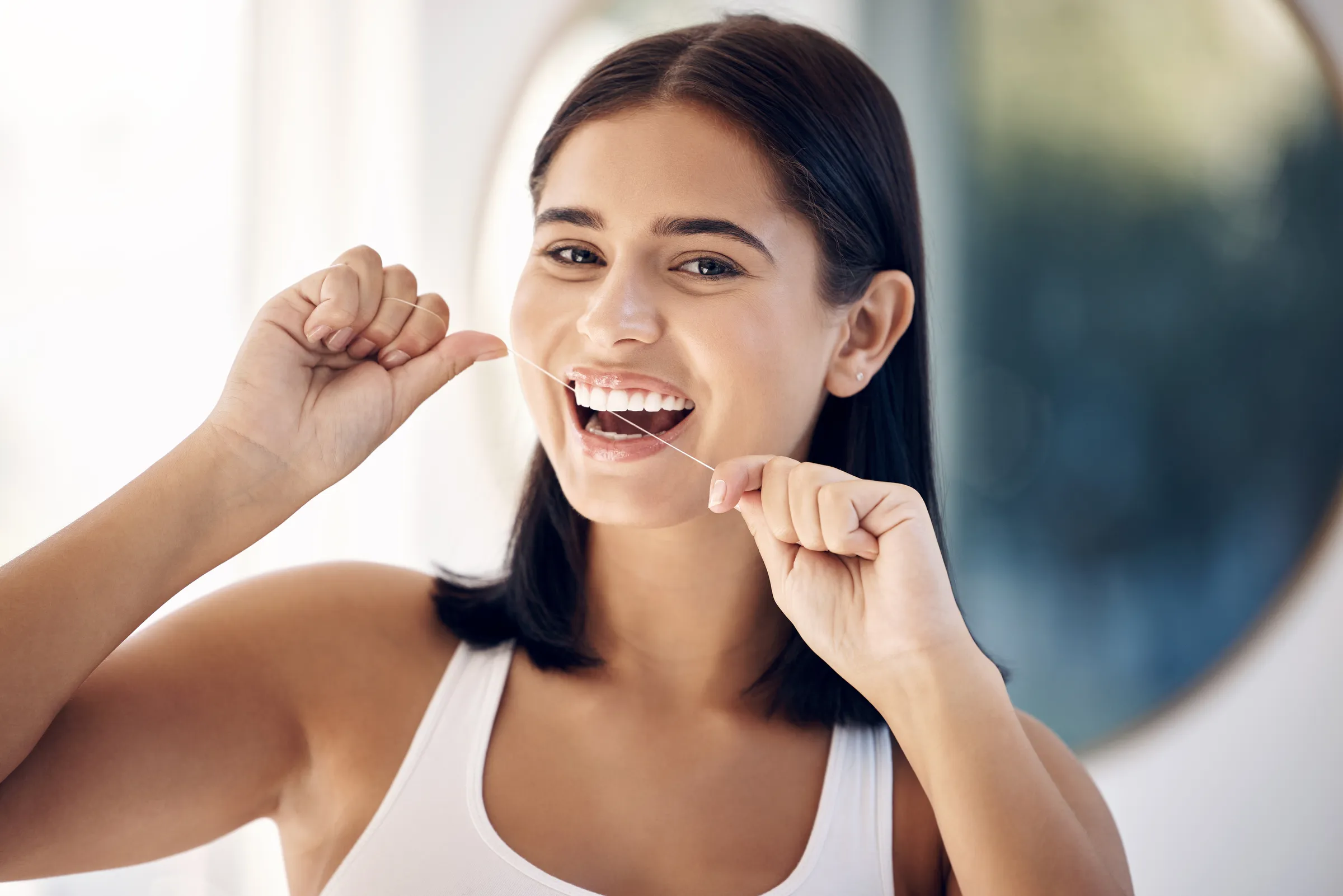 Woman flossing her teeth