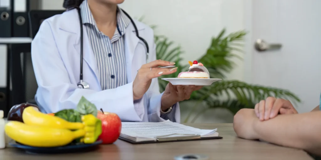 Dentist discussing healthy food choices with a patient