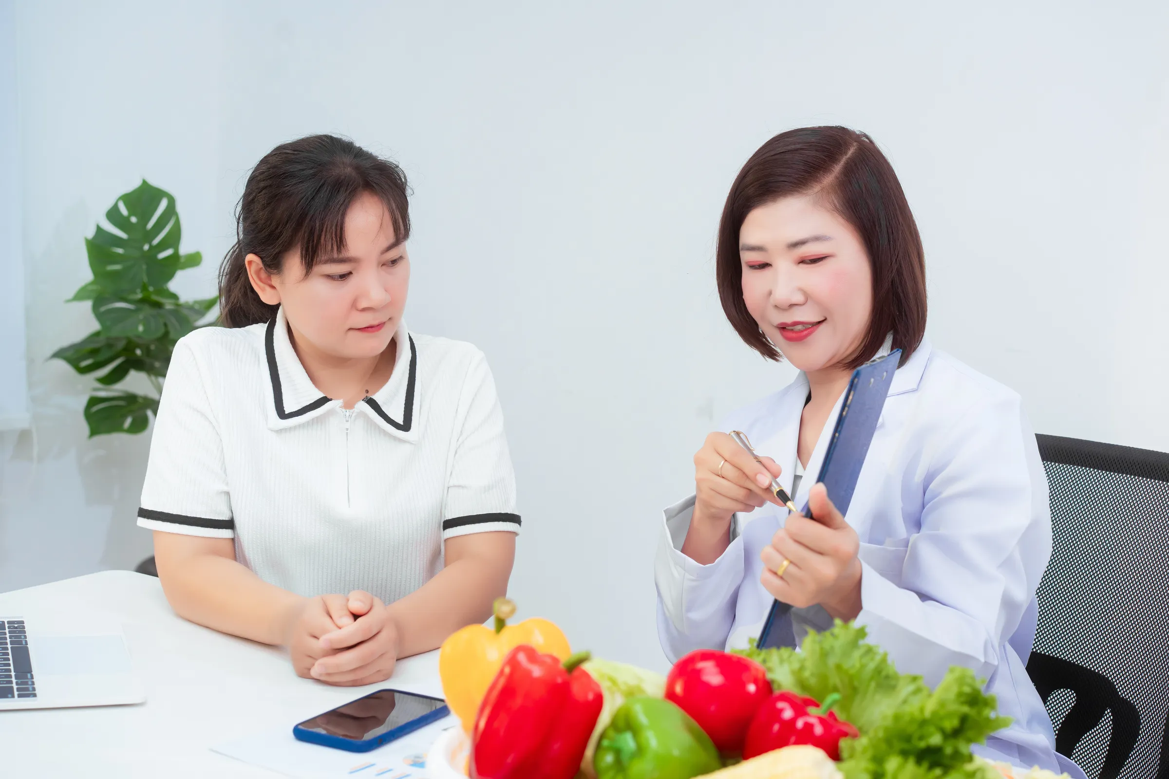 Nutrition counseling with fresh vegetables on the desk