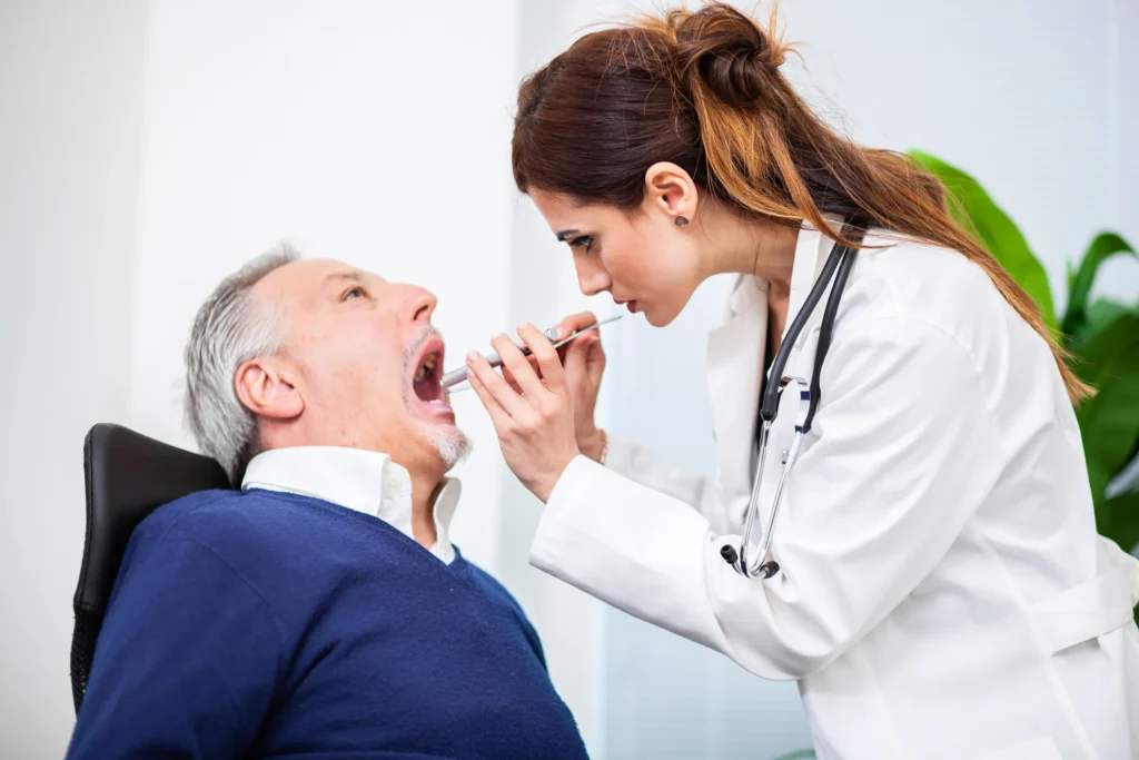 Dentist performing an oral cancer screening