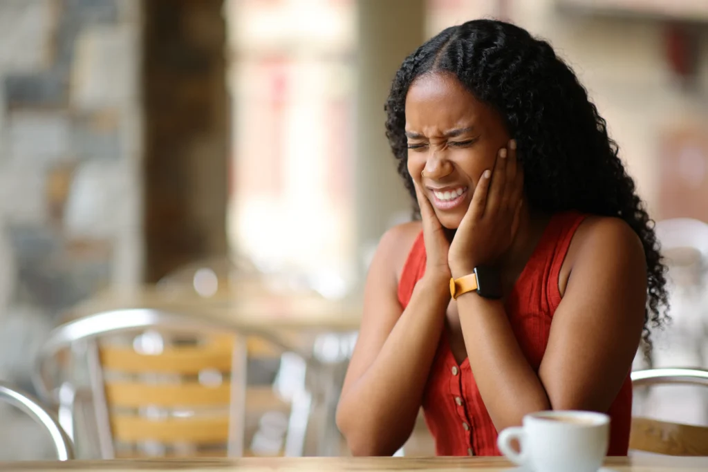 Woman holding her jaw in pain