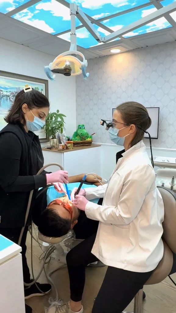 Dentist with a patient in a treatment room at Pacific Dental Care