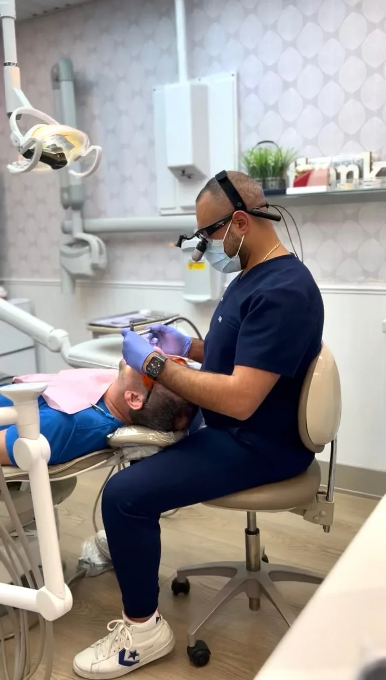 A dentist treating a patient using magnifying loupes