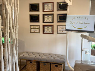Framed credentials above the waiting bench