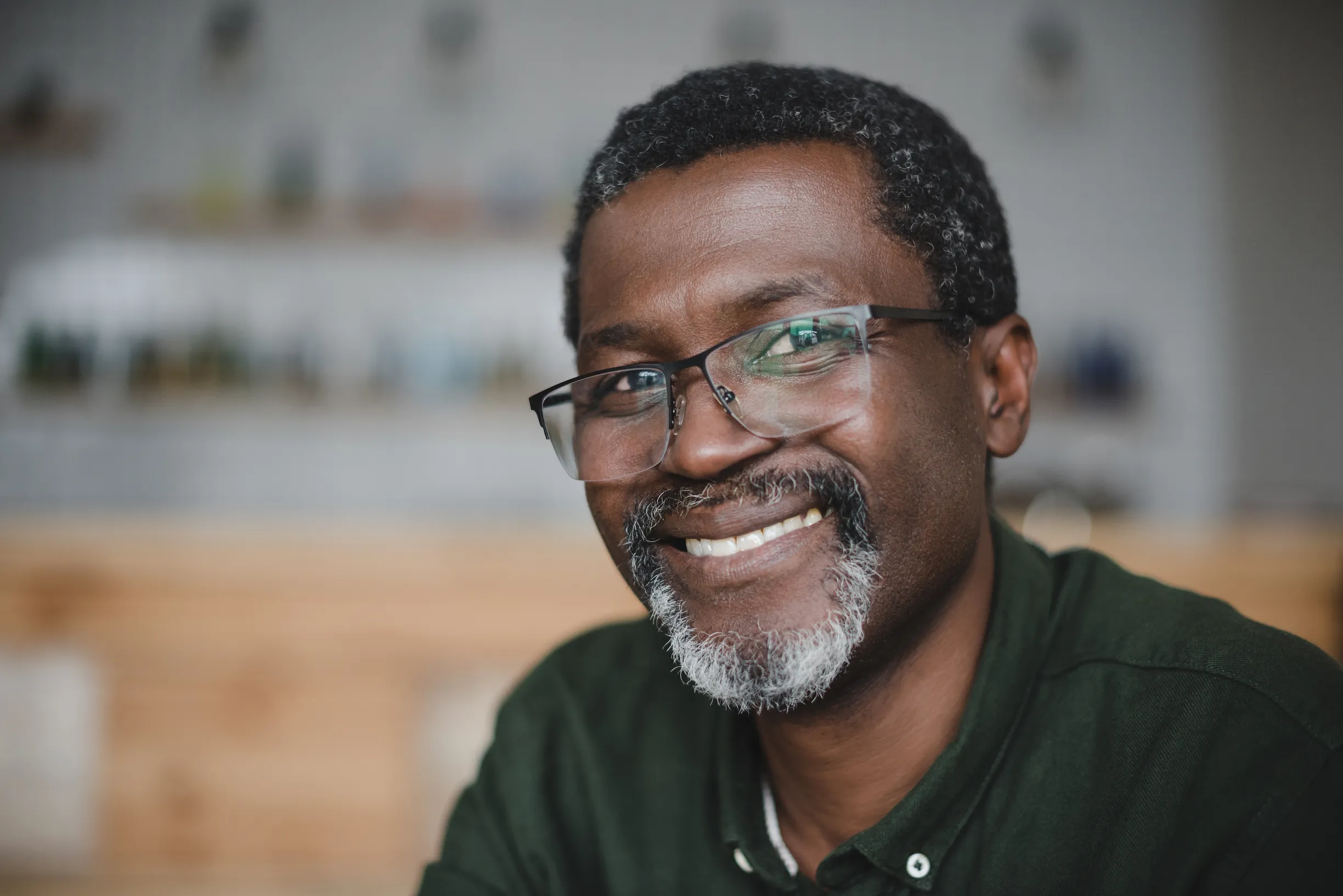 A smiling man wearing glasses